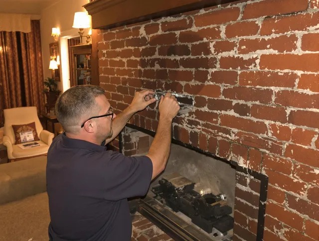 West Hollywood Chimney Sweep expert fixing a fireplace in West Hollywood, CA